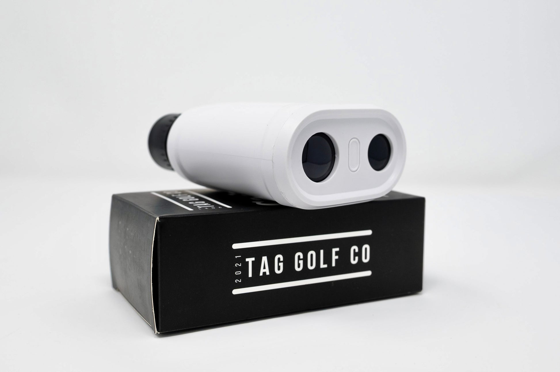 White golf rangefinder on a black TAG GOLF CO box against a white background