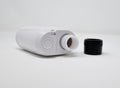 White bottle with a black cap on a white background